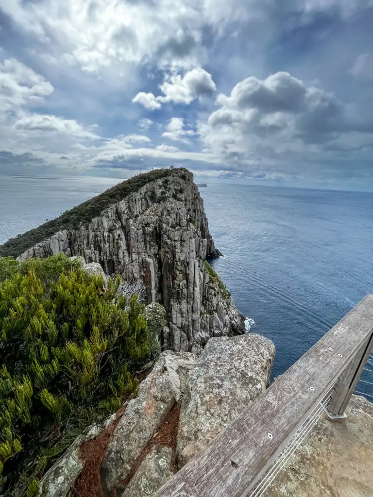 Hiker standing at Cape Pillar on the Three Capes Track