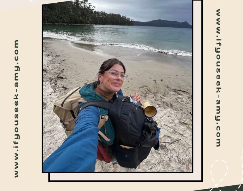 Solo traveler at the beach with two large backpacks, showing compact travel packing.