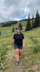Zorali Women’s Rugged Recycled Shorts review – midsize hiker walking through wildflowers